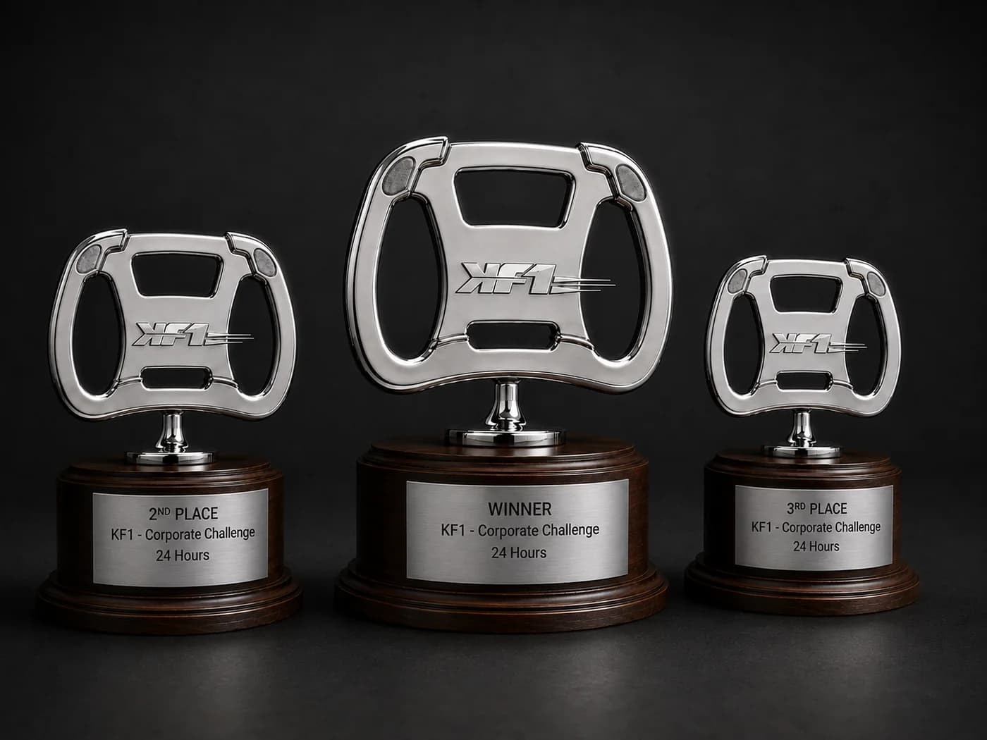 Three steering-wheel trophies on wooden bases, with plates for the winner, second place and third place